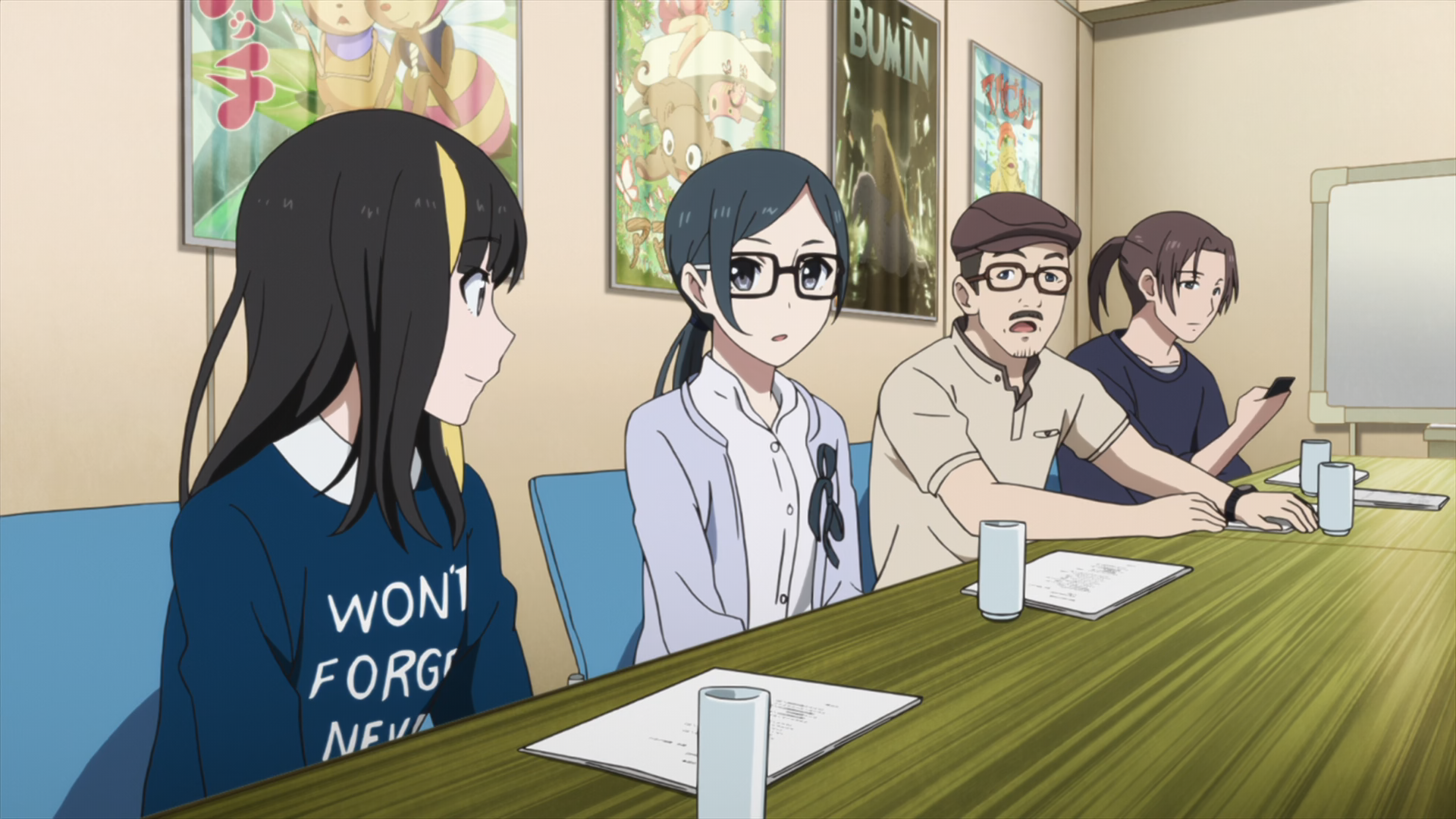 A group of characters from Shirobako in a meeting one of them wearing a shirt with the text: Won't Forget Never