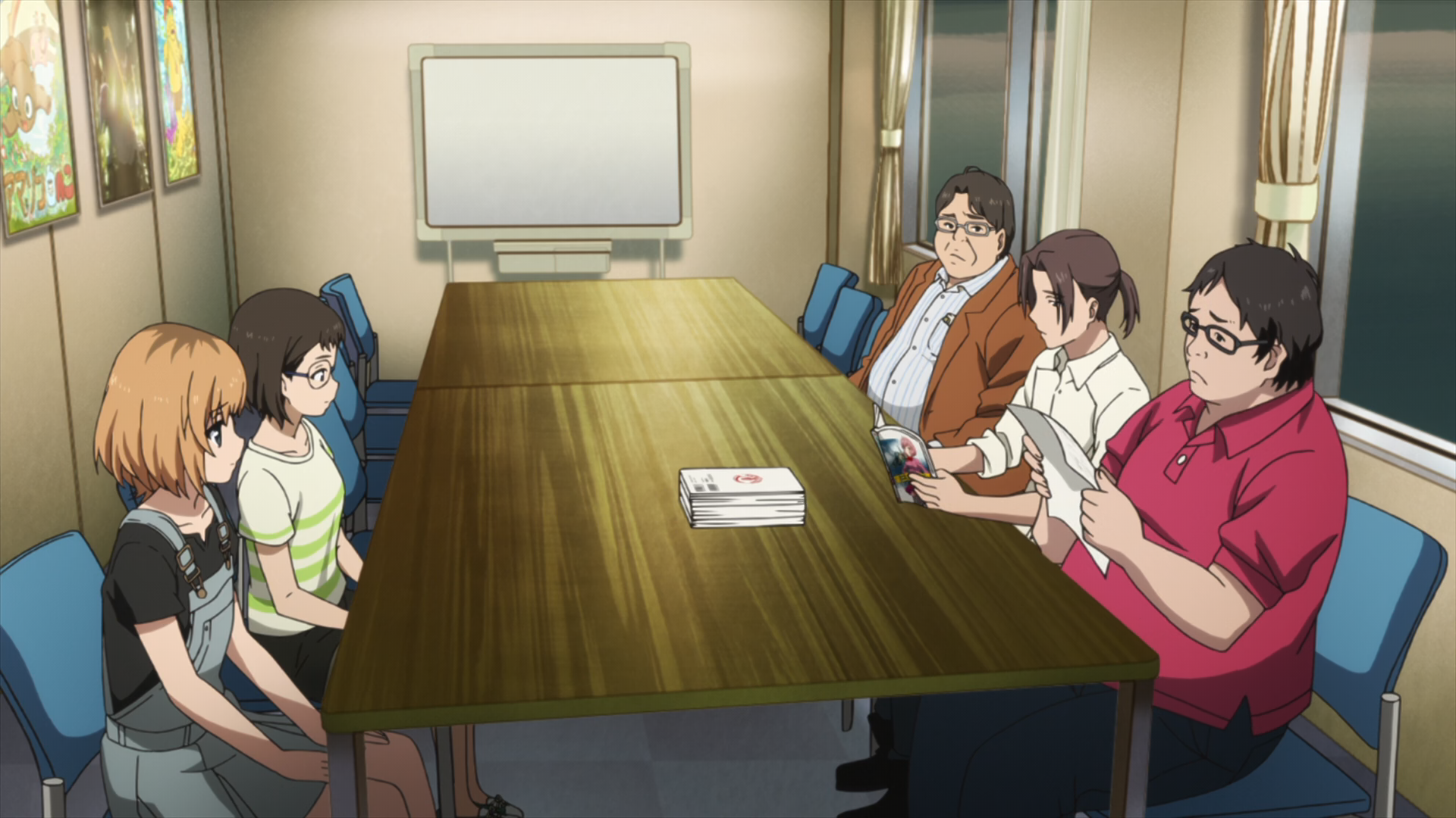 Scene from Shirobako with Aoi and coworkers in a meeting. Aoi is wearing a blue overall dress over a black t-shirt.